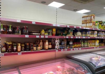 Asian Supermarket shelves and freezers, stocked with Eastern foods.